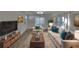 Bright living room featuring hardwood floors, comfy seating, and a large TV at 4978 71St N St, St Petersburg, FL 33709