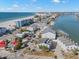 Aerial view of townhomes near beach and waterway, showing location at 9901 1St E St # F, Treasure Island, FL 33706