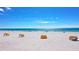 Scenic beach view with calm water and yellow cabanas at 9901 1St E St # F, Treasure Island, FL 33706