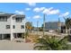 Modern townhome with a paved driveway and tropical landscaping at 9901 1St E St # F, Treasure Island, FL 33706
