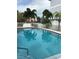 Inviting community swimming pool with palm trees and patio furniture at 9901 1St E St # F, Treasure Island, FL 33706
