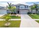Two-story house with gray siding, stone accents, and a landscaped lawn at 11411 Alachua Creek Ln, Riverview, FL 33579