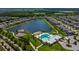 Aerial view of Southfork Lakes community, showcasing a lake, pool, playground, and homes at 11411 Alachua Creek Ln, Riverview, FL 33579