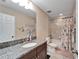 Clean bathroom with a shower/tub combo and granite countertop at 11411 Alachua Creek Ln, Riverview, FL 33579