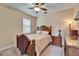 Cozy bedroom with wooden bed frame and ceiling fan at 11411 Alachua Creek Ln, Riverview, FL 33579