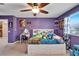 Purple bedroom with a full-size bed and plenty of storage at 11411 Alachua Creek Ln, Riverview, FL 33579