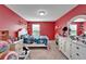 Red bedroom with twin-size bed and white dresser at 11411 Alachua Creek Ln, Riverview, FL 33579