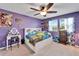 Bright bedroom with a full-size bed, dresser, and vanity at 11411 Alachua Creek Ln, Riverview, FL 33579