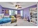 Fun bedroom with purple walls, a bed, and plenty of storage at 11411 Alachua Creek Ln, Riverview, FL 33579