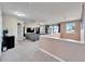 Spacious bonus room with built-in shelving and a large sectional sofa at 11411 Alachua Creek Ln, Riverview, FL 33579