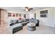 Comfortable bonus room with sectional sofa and ceiling fan at 11411 Alachua Creek Ln, Riverview, FL 33579
