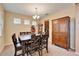 Bright dining room with a wooden table, six chairs, and a buffet at 11411 Alachua Creek Ln, Riverview, FL 33579