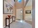 Bright entryway with high ceilings, hardwood floors, and a console table at 11411 Alachua Creek Ln, Riverview, FL 33579