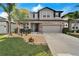 Two-story house with gray siding, stone accents, and a landscaped lawn at 11411 Alachua Creek Ln, Riverview, FL 33579