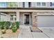 Inviting front porch with stone accents and a black front door at 11411 Alachua Creek Ln, Riverview, FL 33579