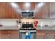 Modern kitchen with stainless steel appliances and granite countertops at 11411 Alachua Creek Ln, Riverview, FL 33579