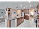 Open kitchen with large island, granite countertops, and stainless steel appliances at 11411 Alachua Creek Ln, Riverview, FL 33579