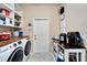 Bright laundry room with washer, dryer, and ample storage at 11411 Alachua Creek Ln, Riverview, FL 33579