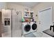Laundry room with washer, dryer, and refrigerator at 11411 Alachua Creek Ln, Riverview, FL 33579