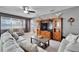 Spacious living room with sectional sofa and wood shelving at 11411 Alachua Creek Ln, Riverview, FL 33579
