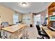 Bright office with a work table and two desks at 11411 Alachua Creek Ln, Riverview, FL 33579