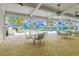 Covered patio area overlooking the community pool with tables and chairs at 11411 Alachua Creek Ln, Riverview, FL 33579