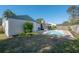 Kidney-shaped pool with screened enclosure in backyard at 12939 116Th St, Largo, FL 33778