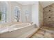 Spa-like bathroom featuring a large soaking tub and a walk-in shower at 224 7Th E St, St Petersburg, FL 33715