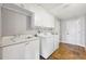 Functional laundry room with white cabinets and tile floor at 224 7Th E St, Tierra Verde, FL 33715