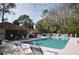 Community pool with lounge chairs and umbrellas at 3480 Hillmoor Dr, Palm Harbor, FL 34685