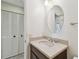 Bathroom featuring a granite vanity with an oval mirror and storage, and a linen closet at 4617 Westford Cir, Tampa, FL 33618