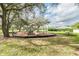 Community playground with slides, climbing structures, and a picnic table in a grassy, shaded area for Gathering fun at 4617 Westford Cir, Tampa, FL 33618