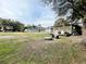 Large backyard with multiple structures and a fire pit at 7424 Lance St, Zephyrhills, FL 33541