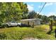 House exterior with a white jeep and a gate at 7424 Lance St, Zephyrhills, FL 33541