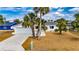 Newly renovated home with a modern white exterior and palm trees at 1009 Spindle Palm Way, Apollo Beach, FL 33572