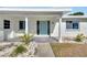 Quaint front porch with teal door and white columns at 1009 Spindle Palm Way, Apollo Beach, FL 33572