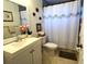 Clean bathroom with white vanity, shower/tub combo, and seashell decor at 12705 Longcrest Dr, Riverview, FL 33579