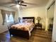 Bedroom with queen-size bed and floral bedding at 12705 Longcrest Dr, Riverview, FL 33579