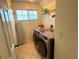 Laundry room with washer, dryer, and overhead shelving at 12705 Longcrest Dr, Riverview, FL 33579