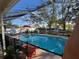 Inviting screened pool area with lounge chairs and patio furniture at 12705 Longcrest Dr, Riverview, FL 33579