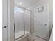 Modern bathroom featuring a glass-enclosed shower and convenient storage space at 30399 Marquette Ave, Wesley Chapel, FL 33545