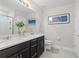 Bright bathroom with double sinks, quartz countertop, and a glass-enclosed shower at 30399 Marquette Ave, Wesley Chapel, FL 33545