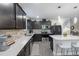 Well-equipped kitchen featuring stainless steel appliances, gray backsplash, and a spacious island with seating at 30399 Marquette Ave, Wesley Chapel, FL 33545