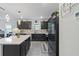 Modern kitchen featuring sleek, dark wood cabinetry and a spacious island with white countertop at 30399 Marquette Ave, Wesley Chapel, FL 33545