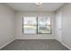 Bright bedroom with neutral walls, carpet, and large window at 4721 Grove Point Dr, Tampa, FL 33624