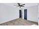 Bright bedroom featuring light wood flooring and navy blue doors at 609 W Henry Ave, Tampa, FL 33604