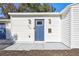 White house exterior with a blue front door and a gray walkway at 609 W Henry Ave, Tampa, FL 33604