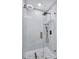 Modern shower with glass enclosure, hexagon tile floor, and gold fixtures at 609 W Henry Ave, Tampa, FL 33604