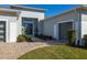 Front entry with modern double doors and landscaping at 9028 Ivy Stark Blvd, Wesley Chapel, FL 33545