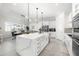 Modern kitchen with white cabinets, quartz island, and stainless steel appliances at 9028 Ivy Stark Blvd, Wesley Chapel, FL 33545